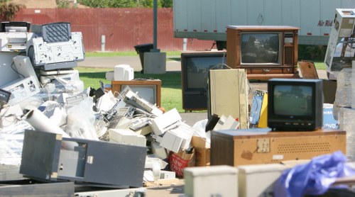 Charity volunteers sorting donated office furniture for reuse